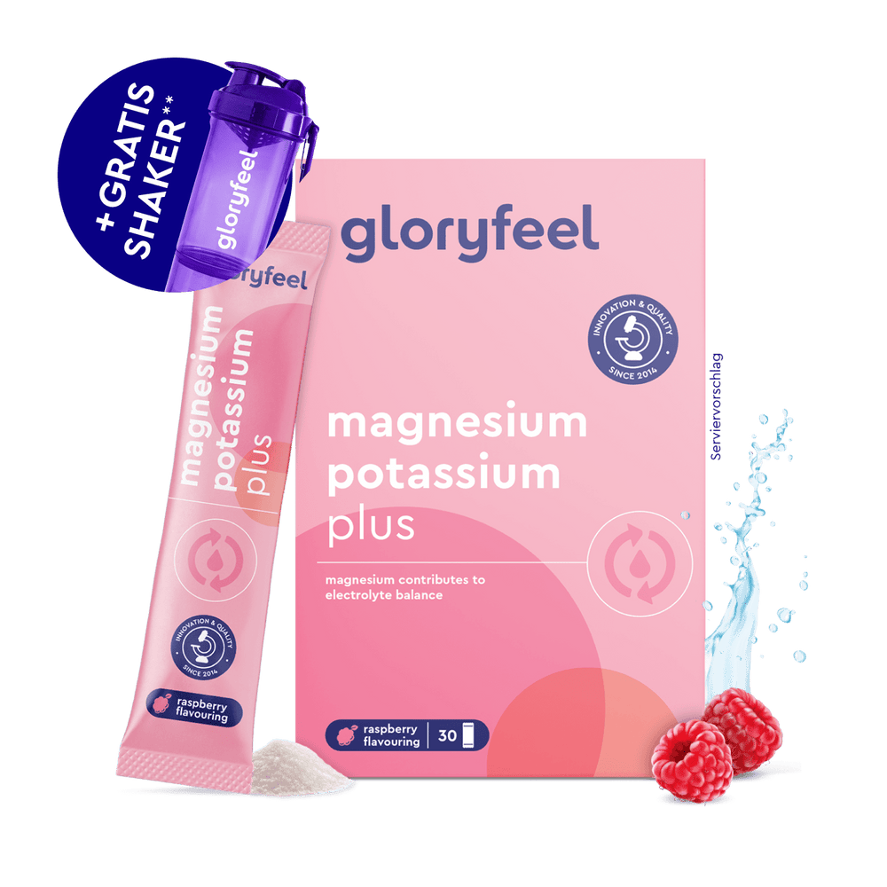 Gloryfeel GmbH Magnesium Kalium Sticks Box mit Sachets, einem lilafarbenen Shaker, Himbeeren, einem Spritzer Milch und dem abgebildeten Produktpulver.